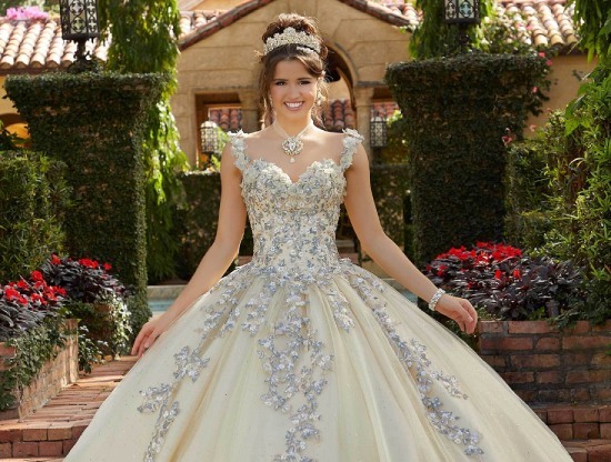 Model wearing a quinceañera gown. Mobile image